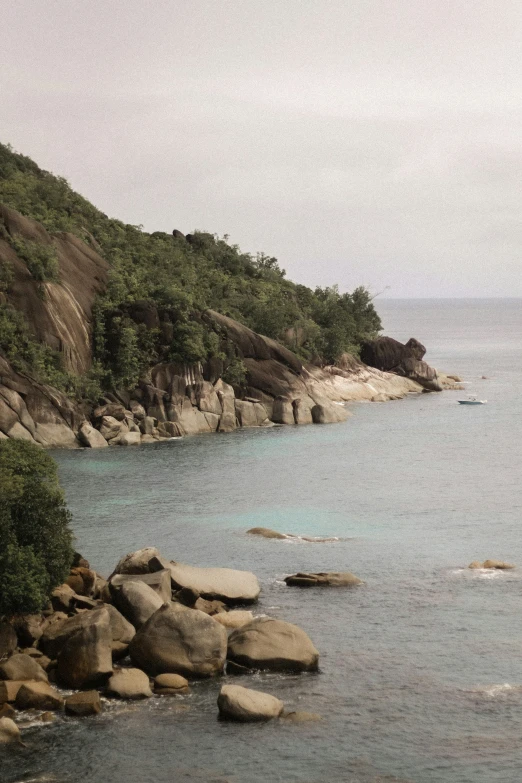 a mountain near the ocean with rocky shores