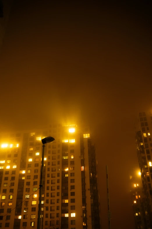 a street light on a foggy city at night