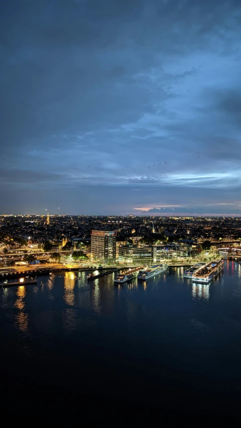 this is a nighttime scene looking down over the city and harbor