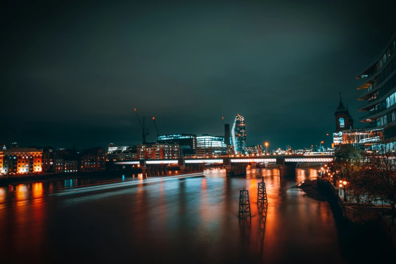 the city lights reflect off the water at night