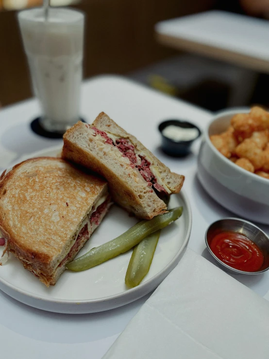 a sandwich cut in half and a side of french fries