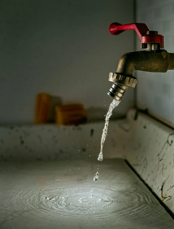 water pouring from the faucet in a kitchen