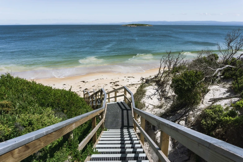 a wooden staircase going down to the beach