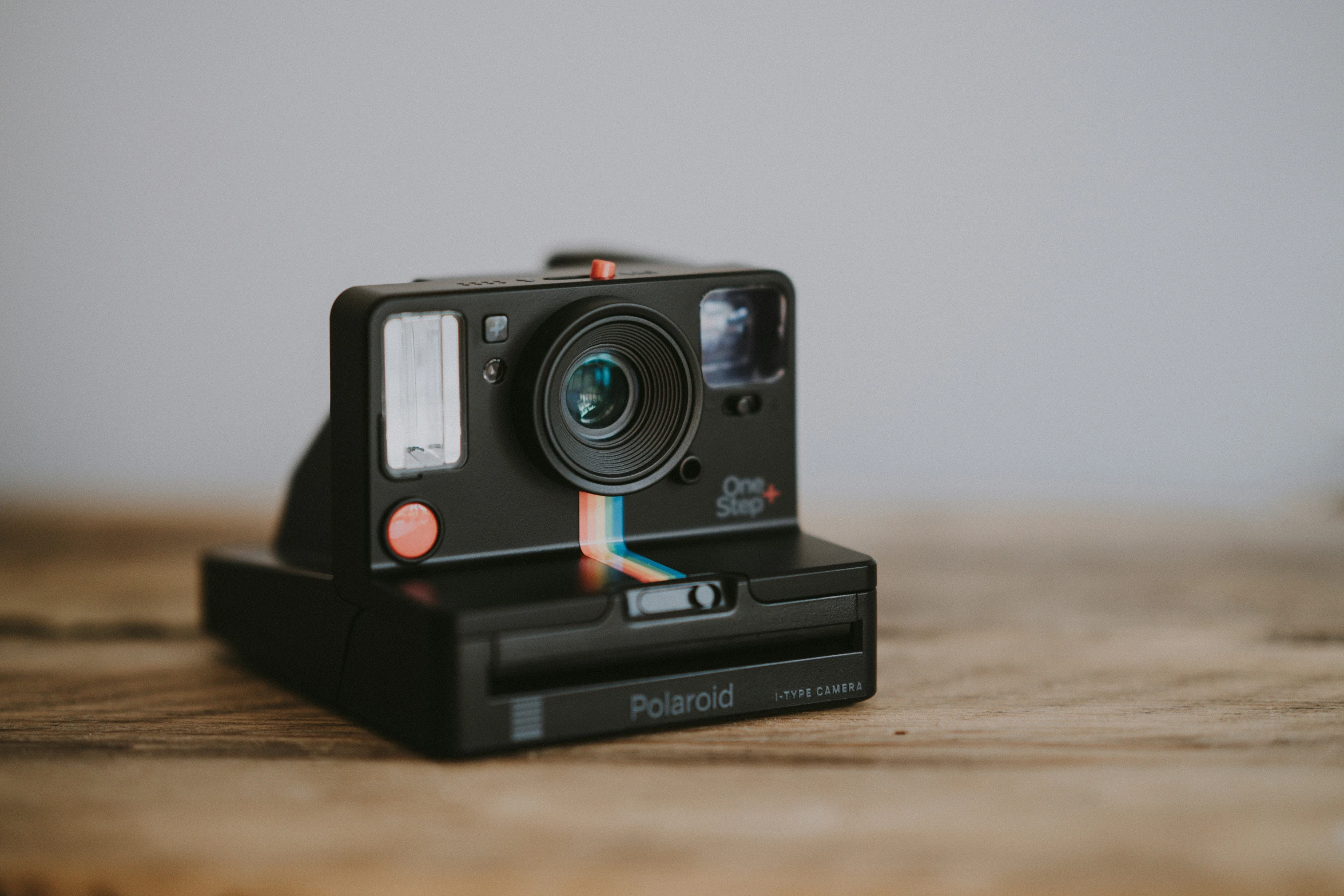 a small black camera sitting on top of a table