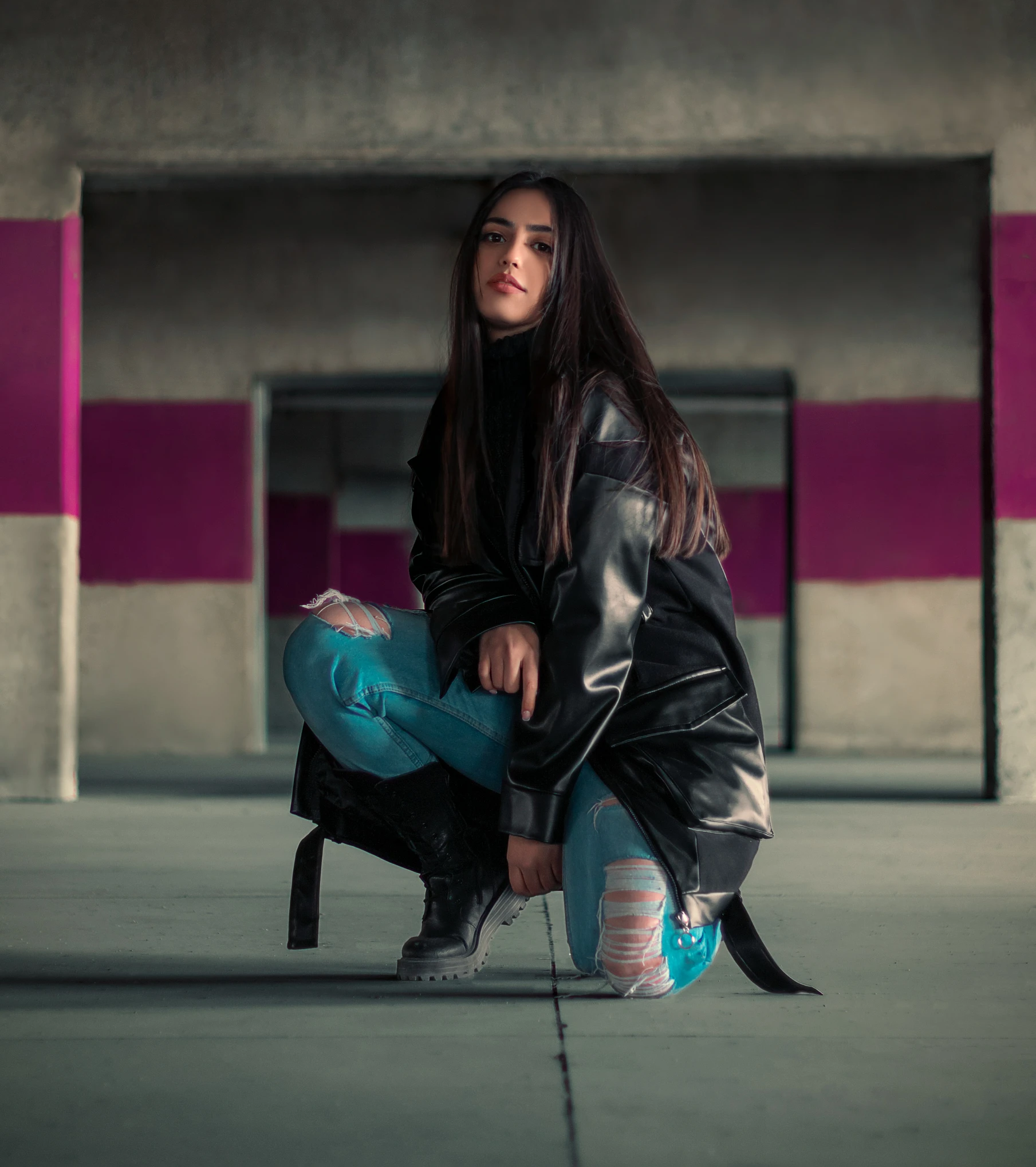 a woman is squatted and posing with a skateboard