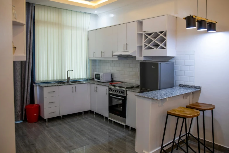 a kitchen with a stove top oven and an island