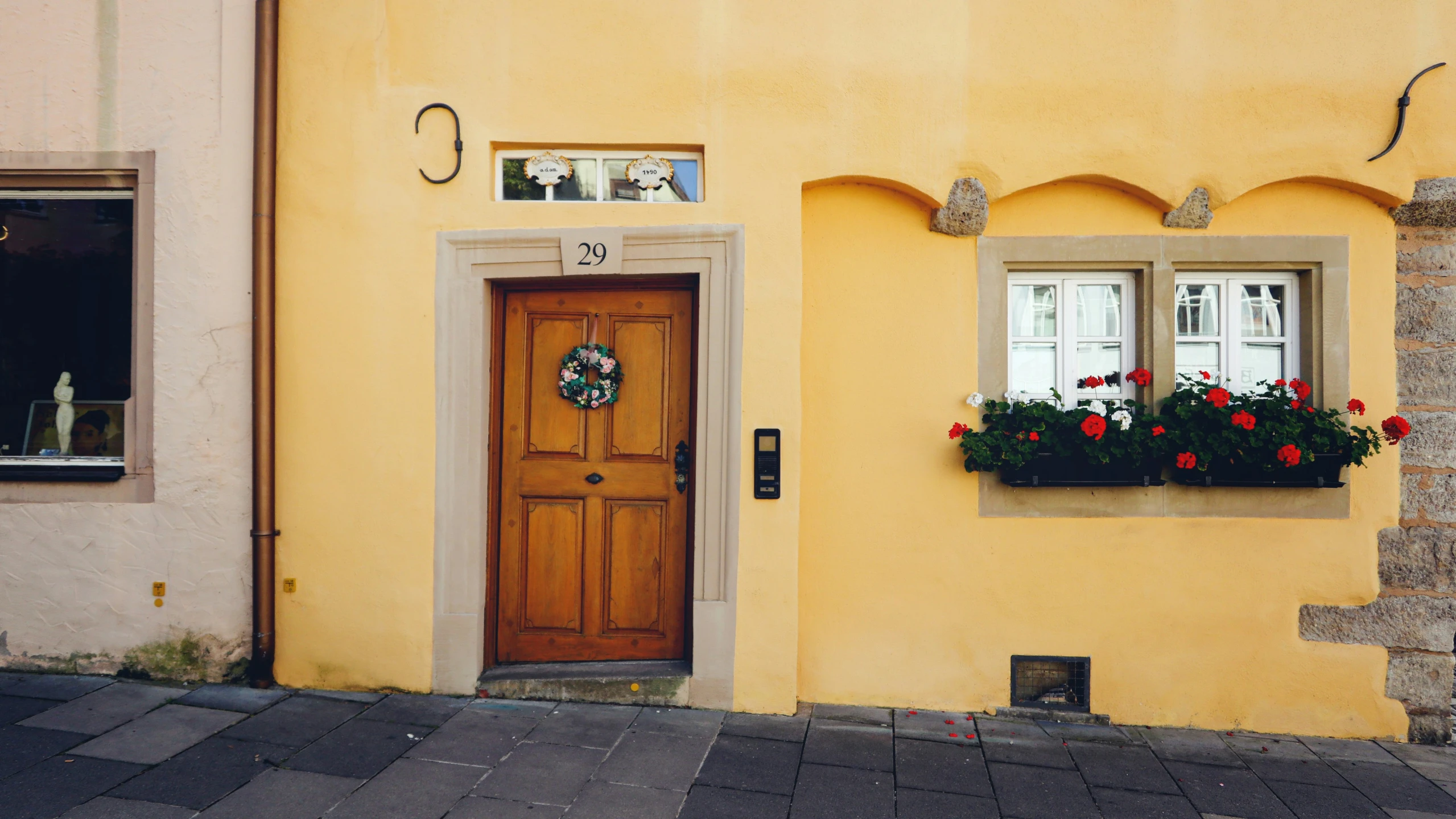 a door and windows on a yellow building