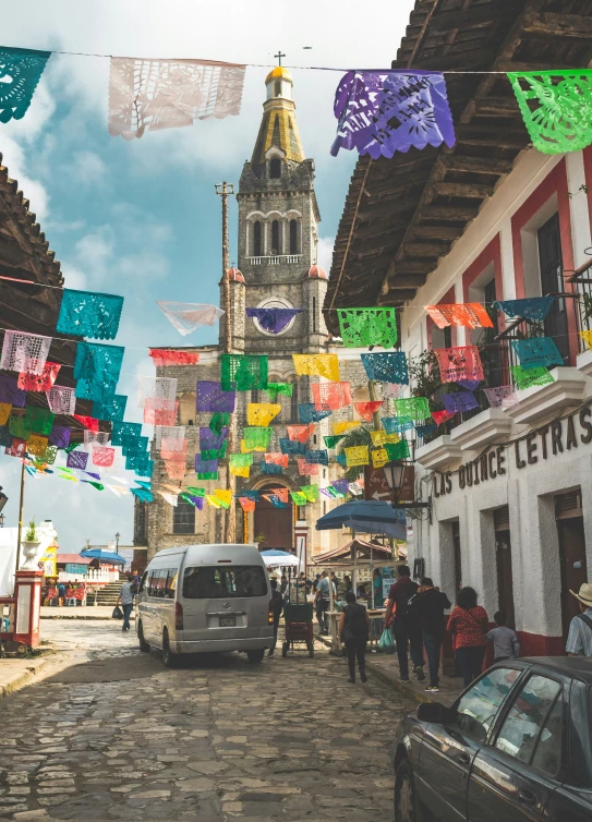 street that has buildings with flags in front and a building on the other side