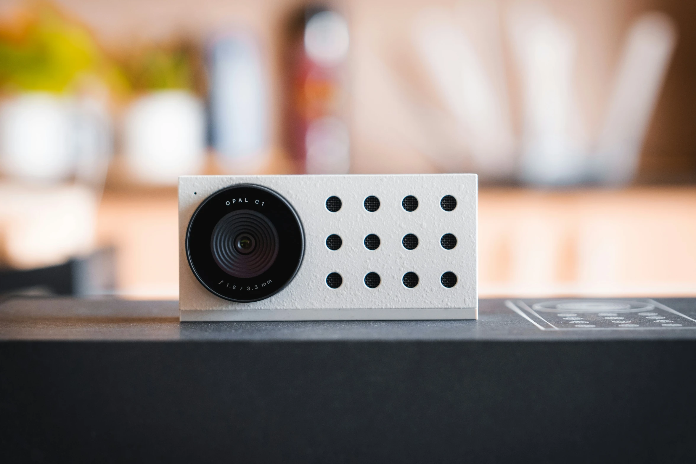 small white camera sitting on top of a table