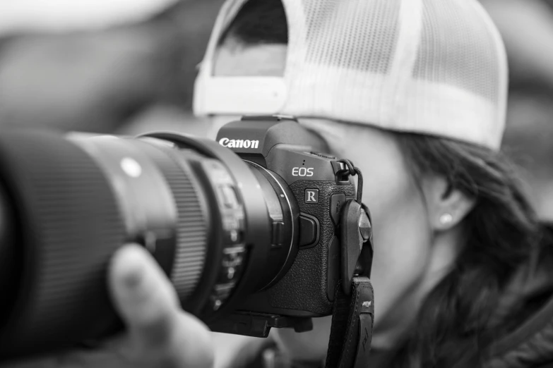 a woman taking a po with a canon camera