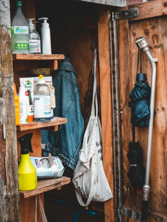 a shelf with several items in it including an overcoat and hood