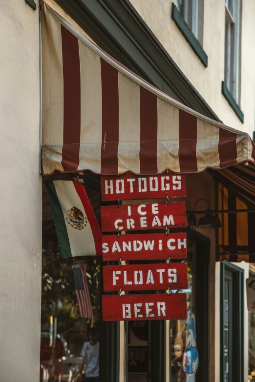 a store sign that says  dogs ice cream sandwich floats beer