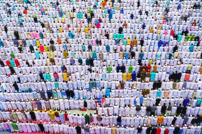 a large group of rows of t - shirts hanging from the ceiling