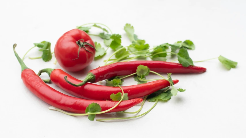 a group of red peppers sitting on top of a table