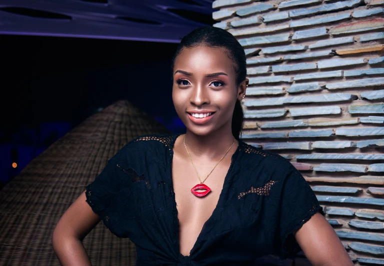 a woman in a black top posing for a picture