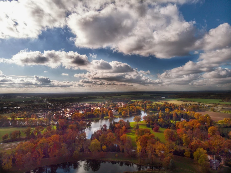 an aerial view of the land with many trees in autumn