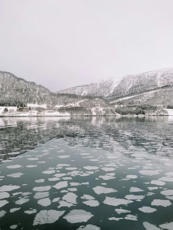 an ice covered river in the middle of winter