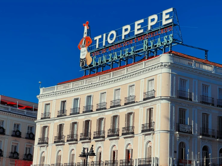 an old building that has a large neon sign on top