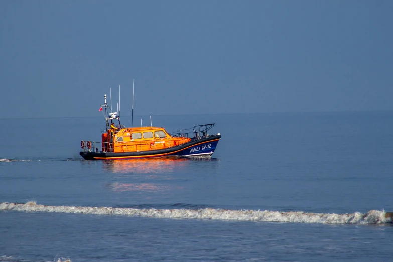 there is an orange boat floating in the water