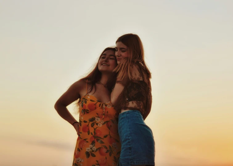 two young ladies stand next to each other