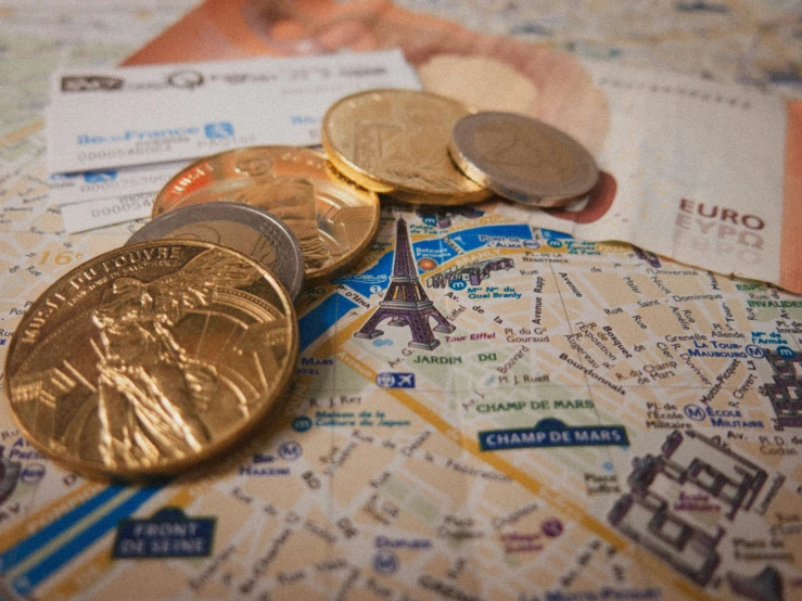 money and passports are on top of a map