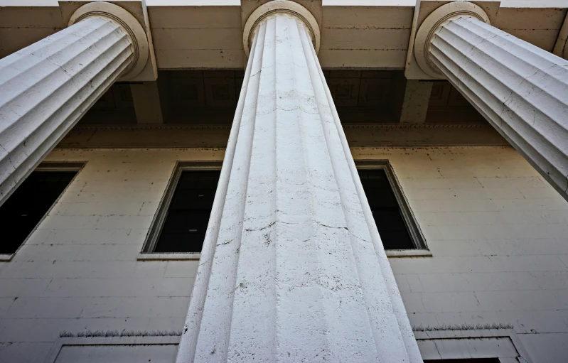 two white columns with a green stop sign