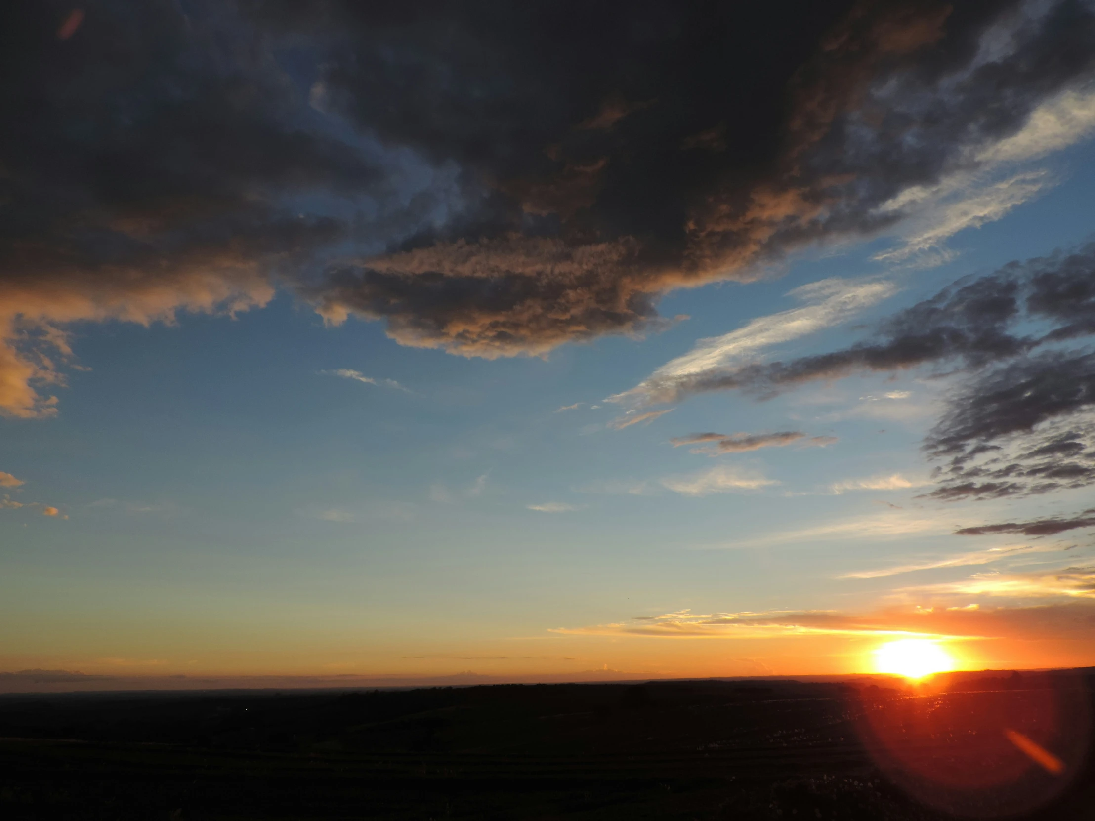 the sunset as seen from the top of the hill