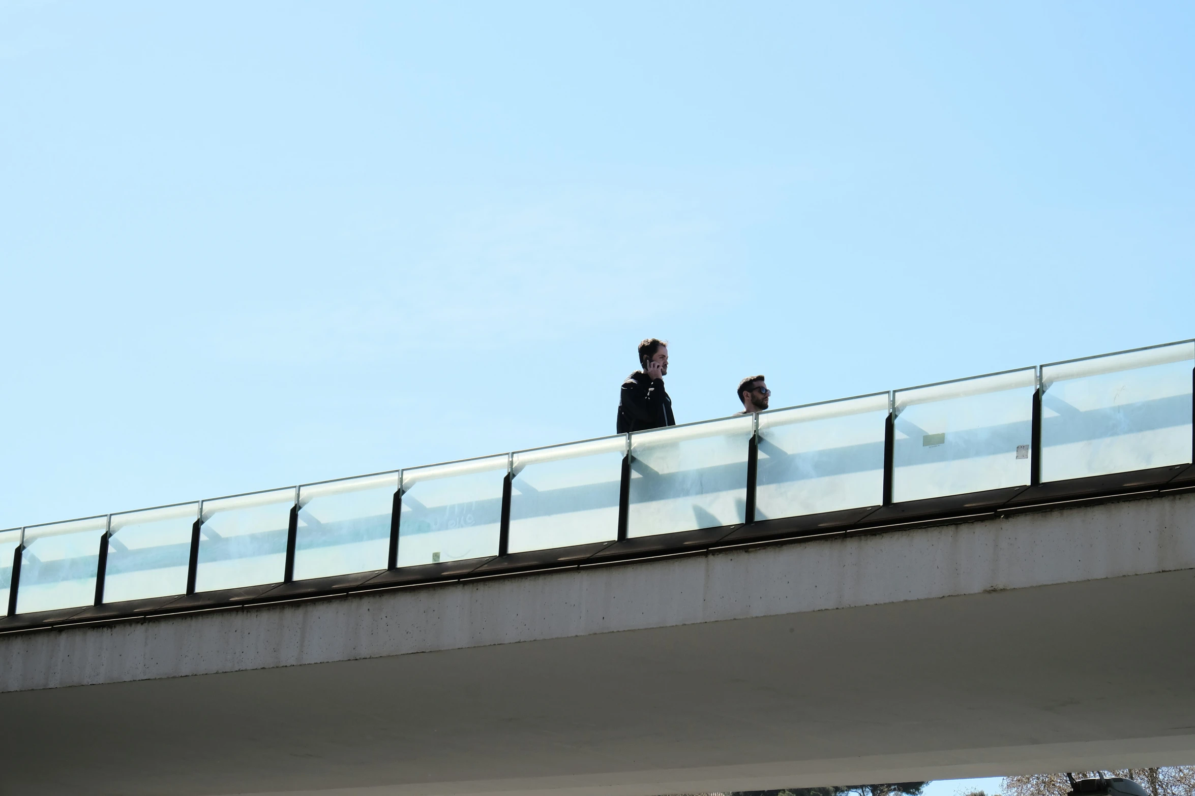 two people walking over the bridge