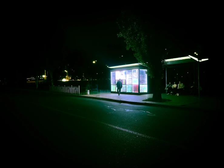 an empty bus stop in a dark area