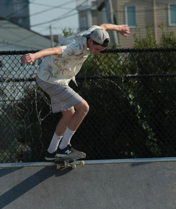 a man riding a skateboard on a concrete ramp