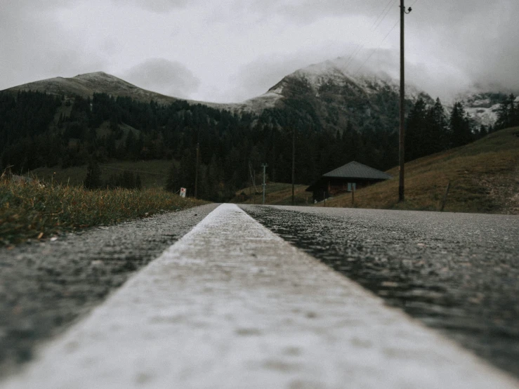 the road is narrow with some clouds in the background