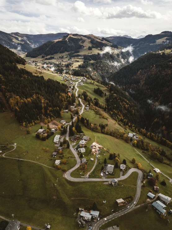 an aerial view of a mountain town and river