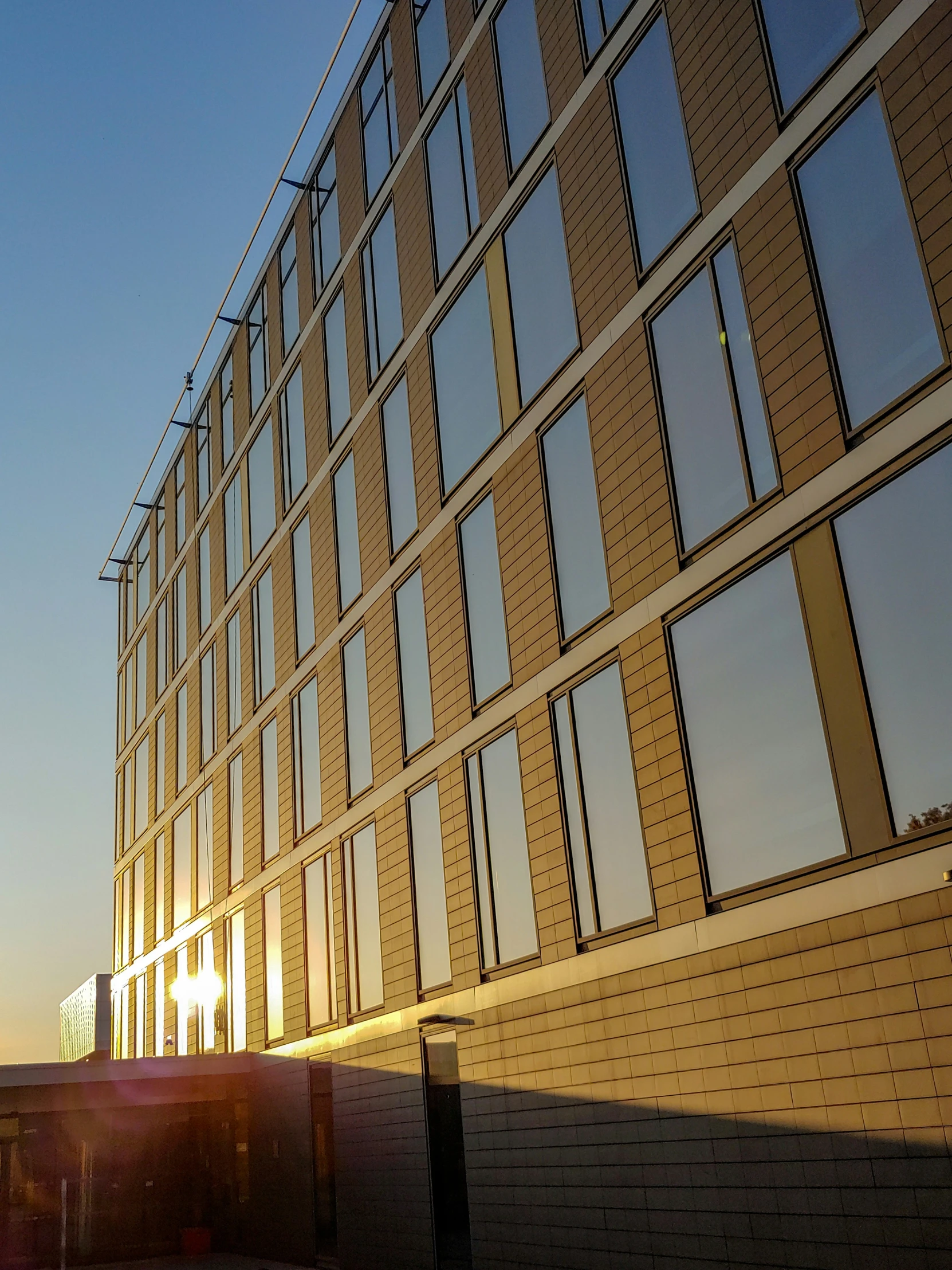 the sun shining through the windows in front of the building