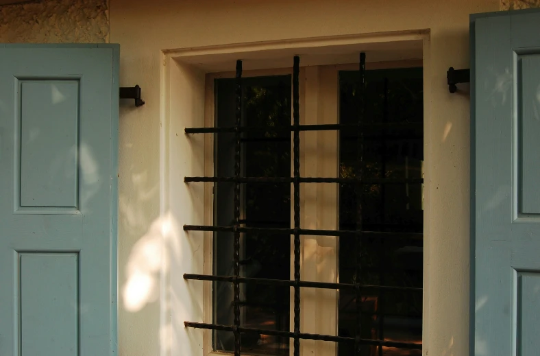 a window that is open with wooden shutters