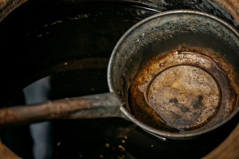 an old metal pot is shown with rust