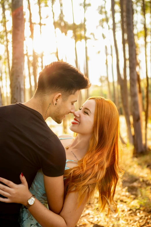 man and woman cuddling with each other in forest