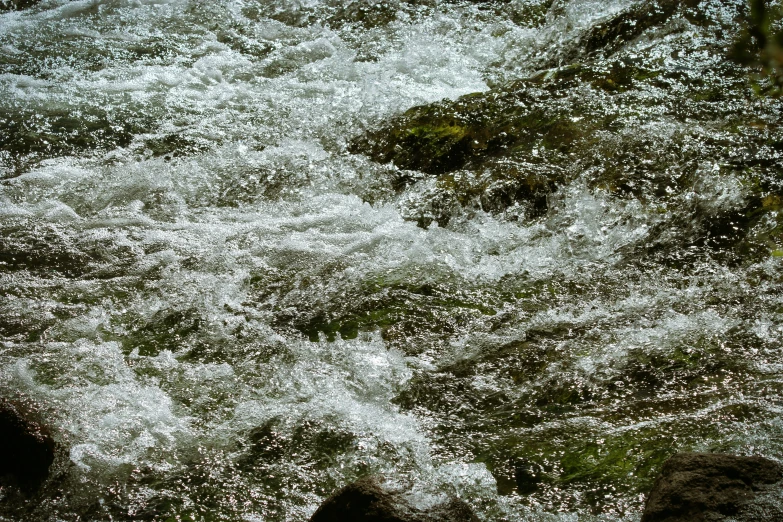 a group of rocks that are next to a body of water