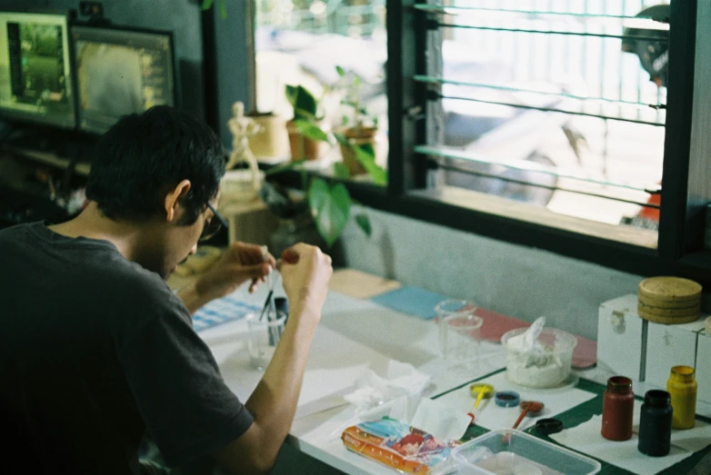 the man is painting in his studio and enjoying it