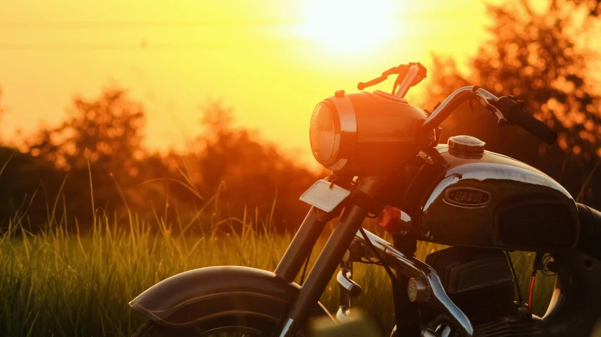 a motorcycle sitting on top of a grass covered field