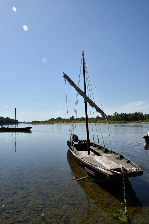 an old fashioned boat sitting in a body of water