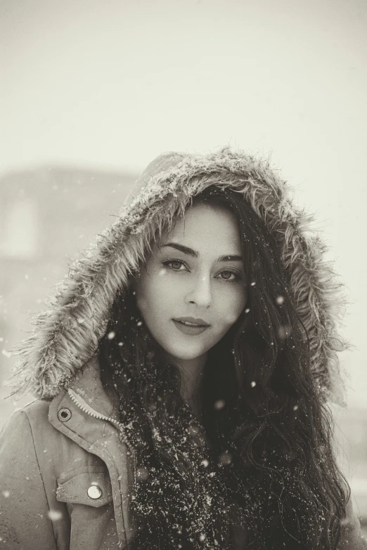 a woman standing on top of a snow covered ground