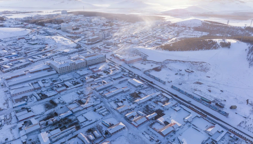 aerial po of buildings on snow - covered landscape