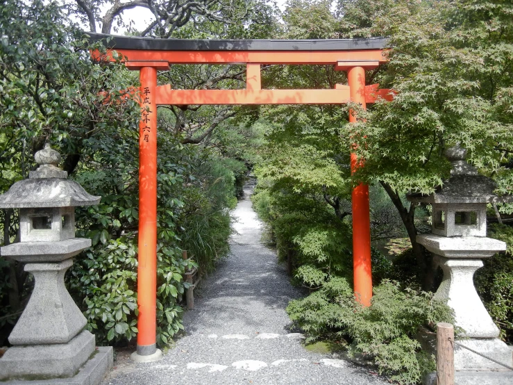 a very old looking pathway with an orange gate