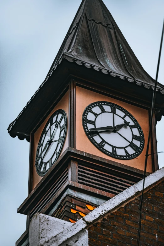 a clock tower has a weather vein on it