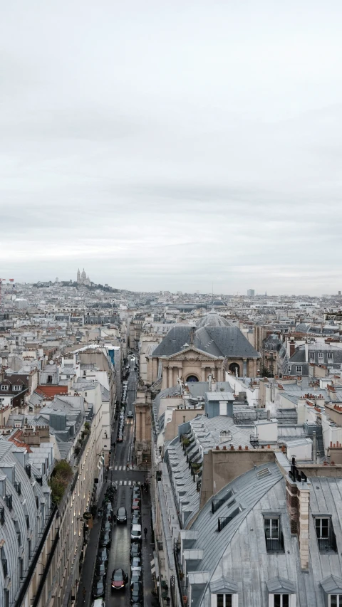 the city is covered in rooftops as cars and buses drive on the street