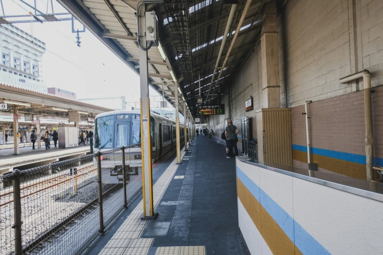 passengers wait to board an over pass train at the station