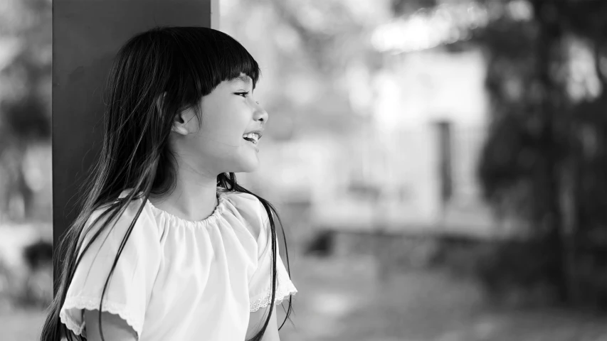 an asian girl in black and white is smiling