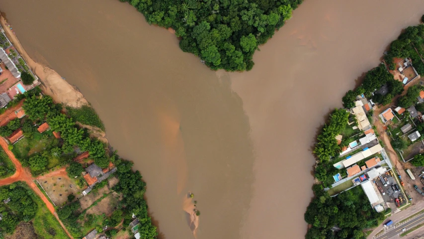 an aerial s of a river with houses on either side