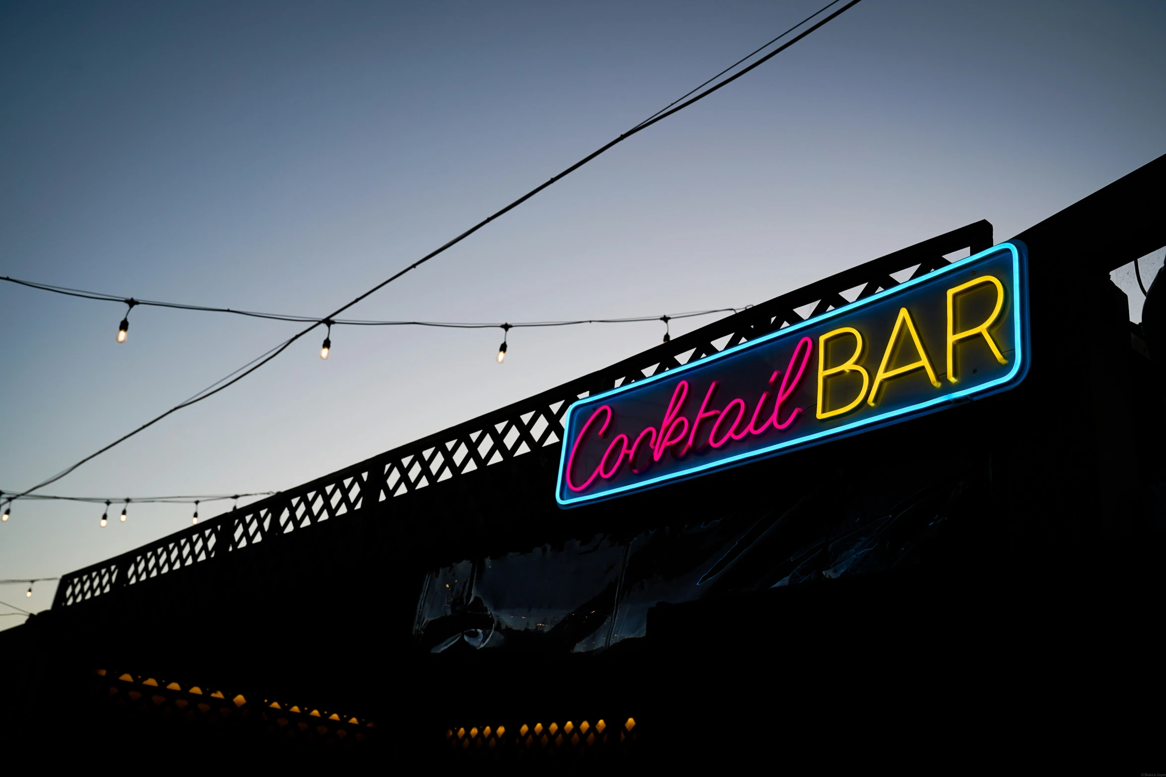 the neon bar sign for cocktail bar is glowing at night