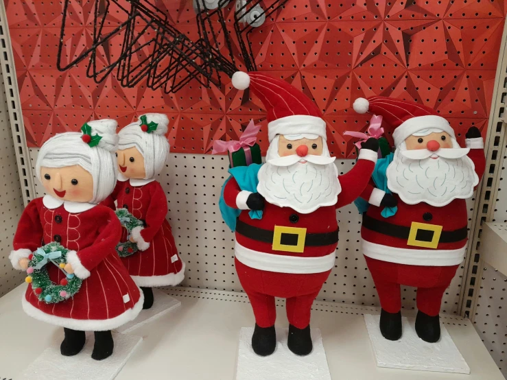 several christmas decorations in the shape of santa clauses